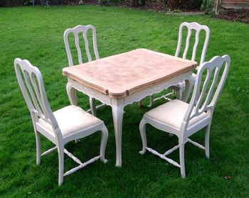 High angle view of table and chairs on grassy field