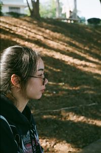 Young woman in sunglasses looking away