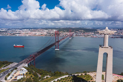 High angle view of city by sea against sky