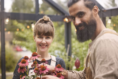 Smiling couple in greenhouse