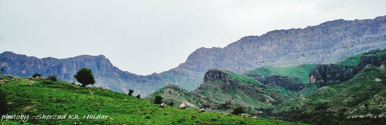 mountain, tranquil scene, tranquility, scenics, beauty in nature, landscape, mountain range, rock formation, clear sky, nature, tree, non-urban scene, rocky mountains, physical geography, geology, idyllic, cliff, rock - object, sky, remote