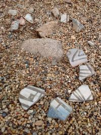 Close-up of pebbles on sand