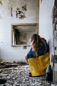 Rear view of woman sitting on chair