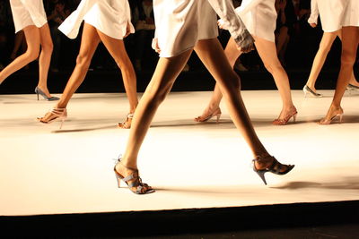 Low section of women doing catwalk on stage