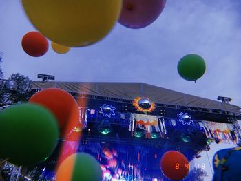 Low angle view of balloons against sky in city