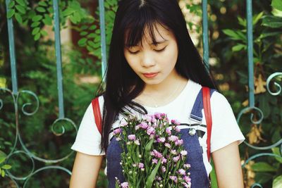 Beautiful young woman holding flowers