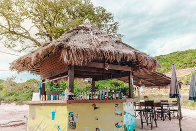 Shop at beach against trees