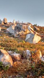 Rocks on landscape against clear sky