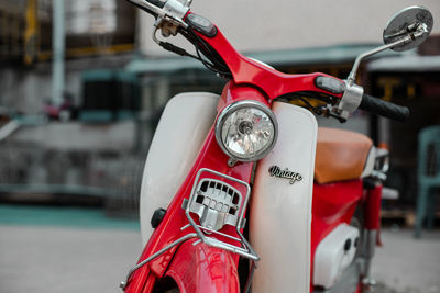 Close-up of red bicycle in city