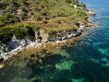 High angle view of rocks on sea shore