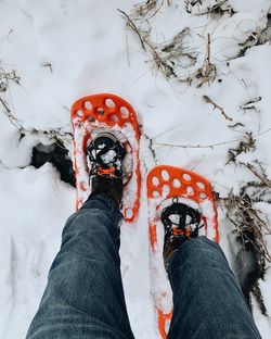 Low section of person on snow field during winter