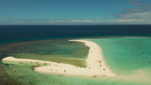 Sandy white island with beach and sandy bar in the turquoise atoll water. sandbar atoll. 