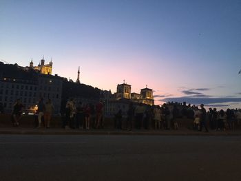 Silhouette of buildings in city at sunset