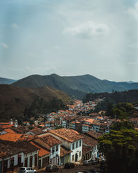 Town by mountains against sky