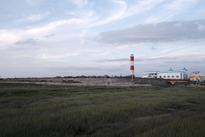 Built structure on field against sky