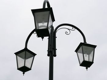 Low angle view of street light against sky