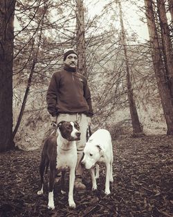 Dog with man in background against sky