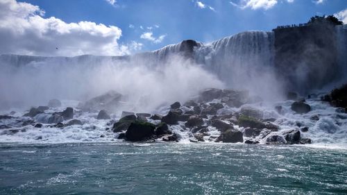 Scenic view of waterfall against sea