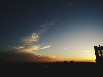 Silhouette cityscape against sky during sunset