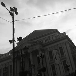 Low angle view of building against cloudy sky