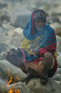 Portrait of man sitting on snow