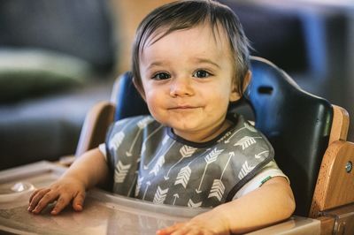 Close-up portrait of cute boy playing at home