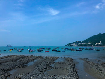 Scenic view of beach against blue sky