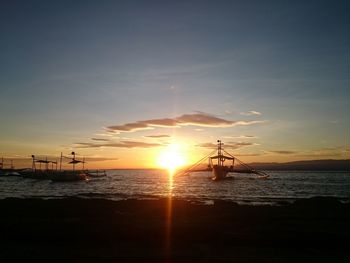 Silhouette ship sailing on sea against sky during sunset