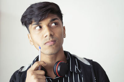 Portrait of young man against white background