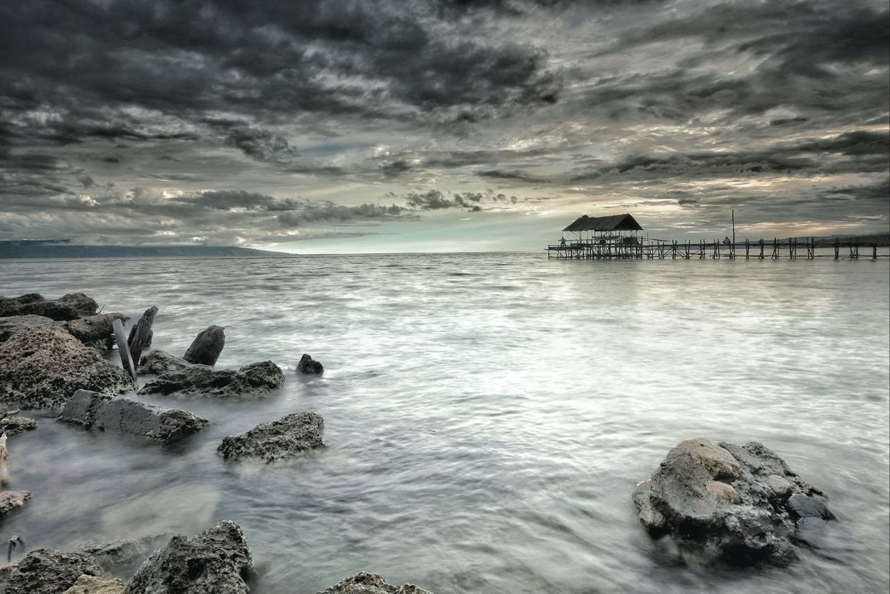 sea, water, sky, cloud - sky, horizon over water, cloudy, scenics, tranquil scene, beauty in nature, tranquility, rock - object, nature, beach, weather, built structure, overcast, cloud, shore, idyllic, pier