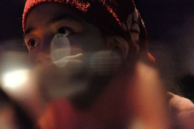 Close-up portrait of young woman looking away