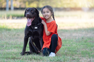 Portrait of a dog standing on field