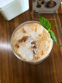 High angle view of iced thai tea in a glass on the table