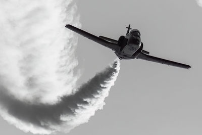 Low angle view of airplane flying against sky