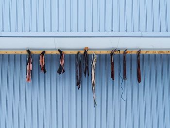 Low angle view of clothes drying against white wall