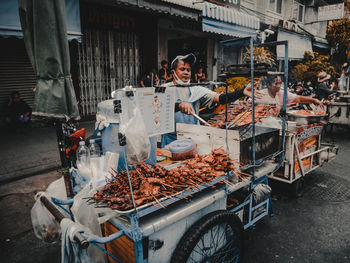 People at market stall in city