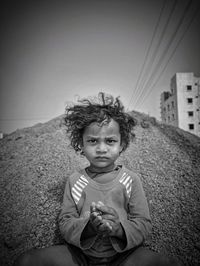 Portrait of boy sitting outdoors