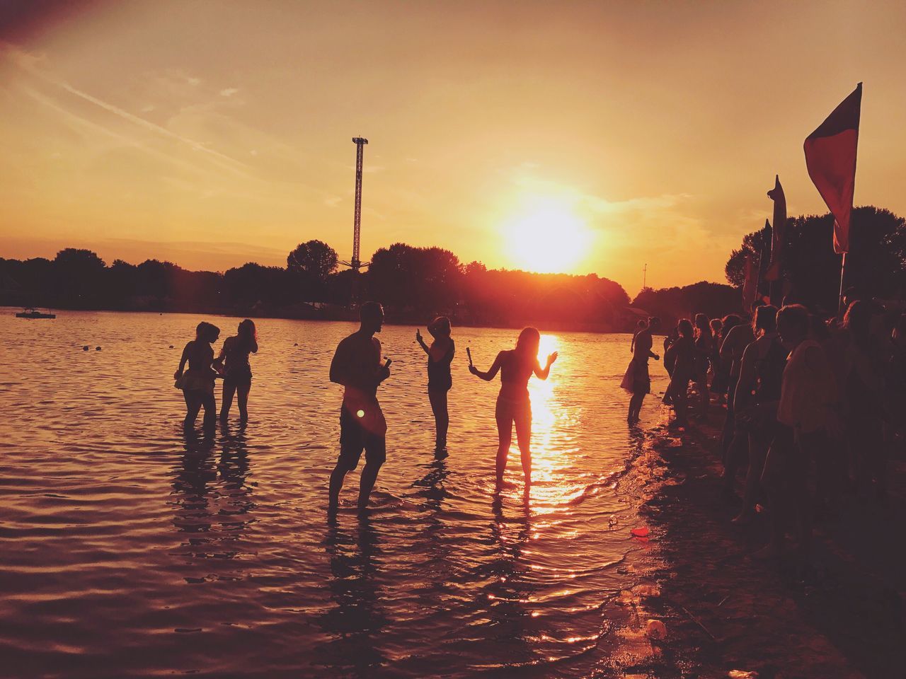 sunset, real people, sky, large group of people, leisure activity, silhouette, enjoyment, nature, togetherness, men, sun, lifestyles, fun, outdoors, water, beach, beauty in nature, friendship, people, adult