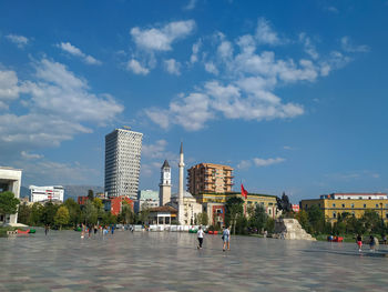 Buildings in town against blue sky