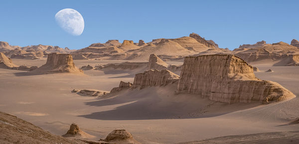 Panoramic view of rock formations in desert against sky