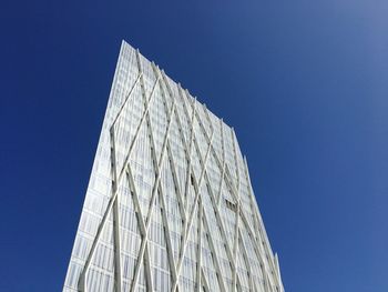 Low angle view of modern building against clear blue sky