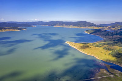 Scenic view of lake and mountains against sky