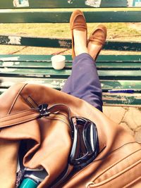 Low section of woman sitting outdoors