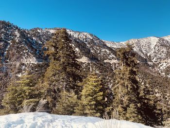 Scenic view of snowcapped mountains against clear blue sky