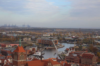 High angle view of river by buildings against sky