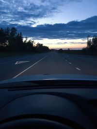 Road against sky seen through car windshield