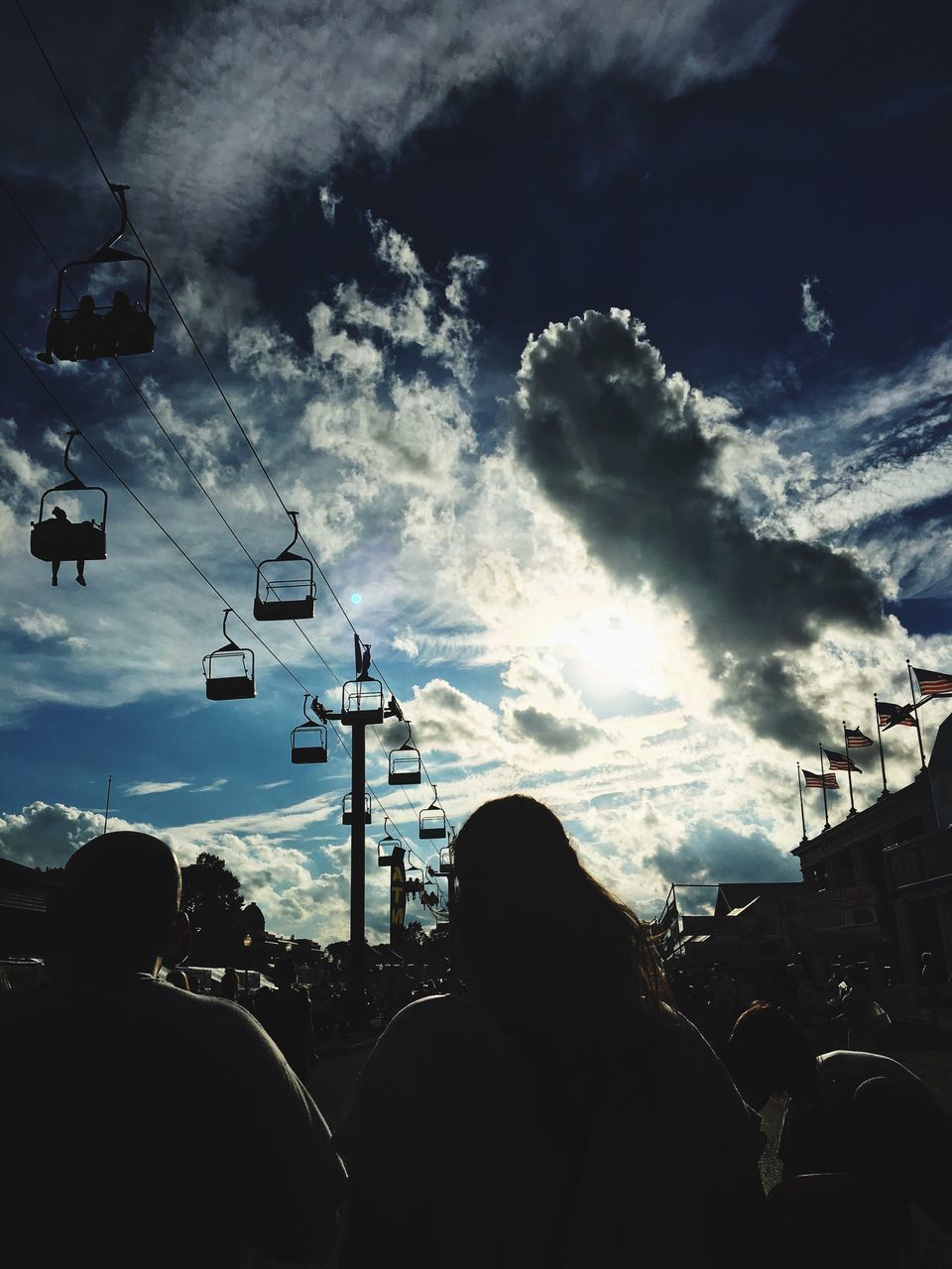 LOW ANGLE VIEW OF SILHOUETTE WOMAN AGAINST SKY