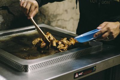 Midsection of man preparing food