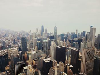 Aerial view of modern buildings in city against sky