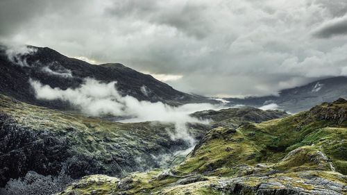 Scenic view of waterfall against sky